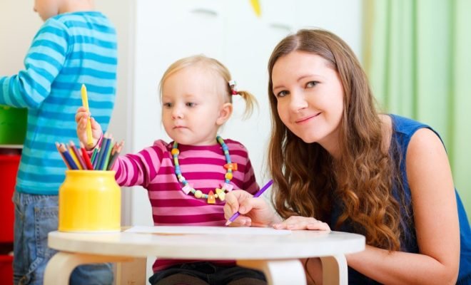 Family at home Mother drawing together with her little daughter