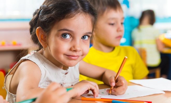 Group of cute little prescool kids drawing Group of cute little prescool kids drawing with colorful pencils